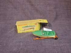 A Dinky diecast, 796 Healey Sports Boat on Trailer in green and white with orange trailer, in