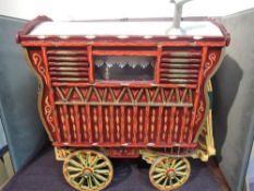 A hand made wooden model Gypsy Bow Top Caravan having hand painted decoration in the traditional