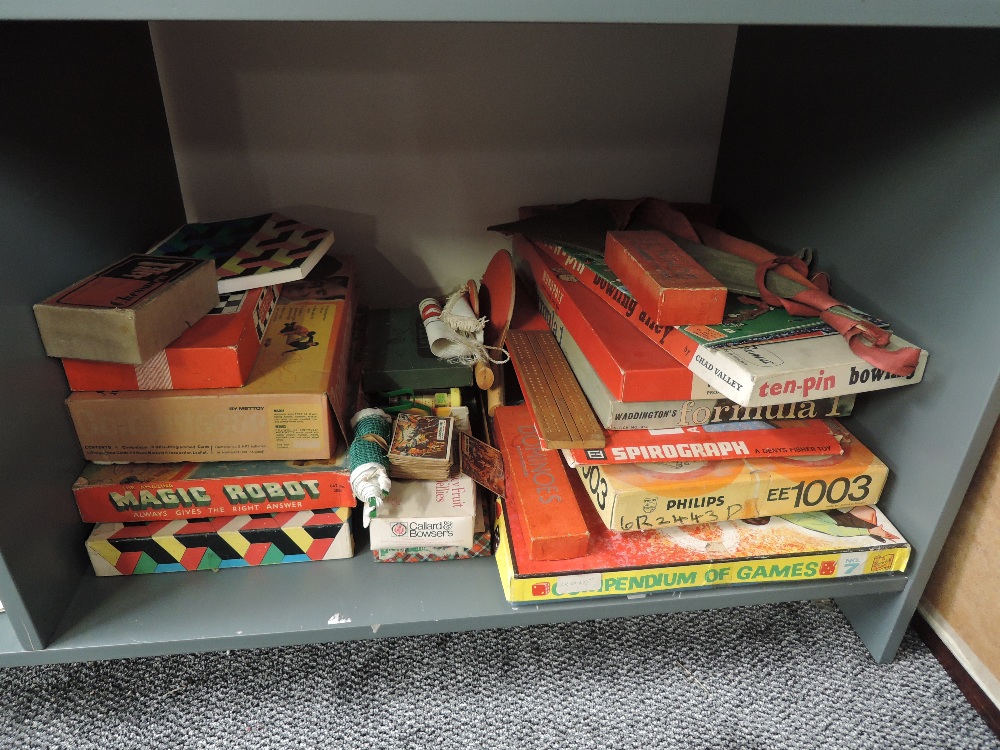 A shelf of vintage Games and Toys including Pendium of Games, Philips EE1003, Magic Robot,