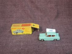 A Dinky diecast, 155 Ford Anglia in turquoise with red interior, in original box