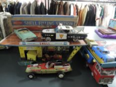 A Mettoy tin plate Shel Filling Station in original box along with three tin plate cars, Police,