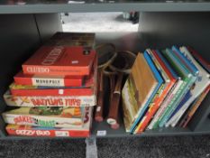 A shelf of vintage Games and Annuals including Ideal Battling Tops, Petter Pan Snakes in the