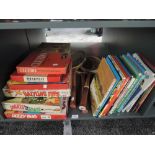 A shelf of vintage Games and Annuals including Ideal Battling Tops, Petter Pan Snakes in the