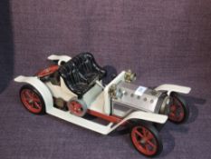 A Mamod Live Steam Roadster in white with black seat
