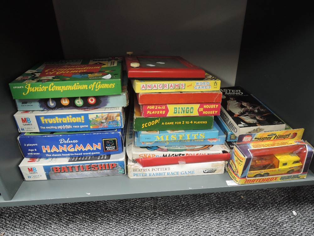 A shelf of vintage games including Battleships, Hangman, Scoop, Gibsons Peter Rabbit Race Game,