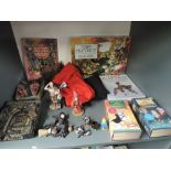 A shelf of Terry Pratchett Volumes, similar figures, Video's and T-Shirts including Unseen