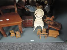 A shelf of mixed scale Dolls House furniture including wooden chest of drawers, chairs, rocking