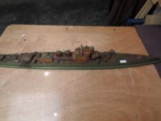 A wooden hand made model of a Battleship, length 110cm