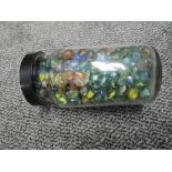 A plastic jar of mixed vintage Marbles including mixed sizes, various patterns and colours