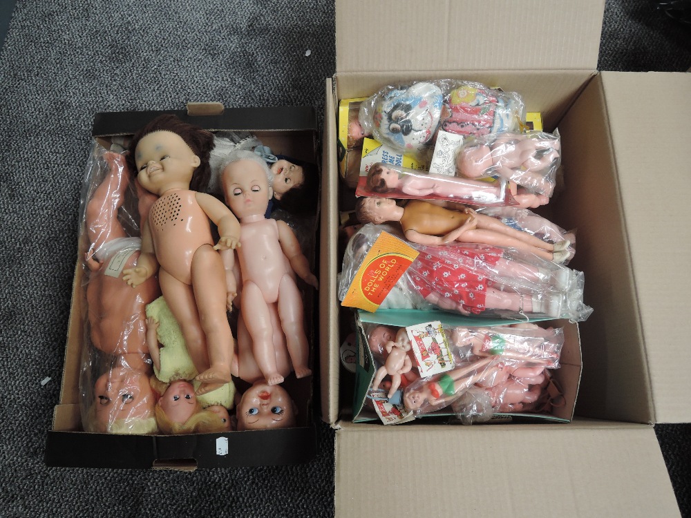 Two boxes of mid 20th century and later celluloid and similar plastic dolls including Empire, Mattel