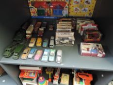 A shelf of mixed vintage diecasts including playworn Dinky & Corgi including Military, Wagons and