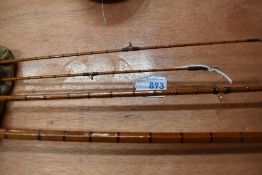 A 3 piece split cane fly rod by Edminson Alnwick with spare tip in canvas sleeve