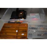 A large selection of fishing lures and spinners in boxes