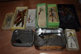 A selection of vintage lures and minnows in boxes and tins including Hardy