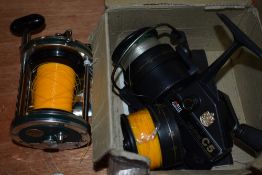 An ABU Garcia Cardinal C5 reel and a Shakespeare 2151 multiplier reel