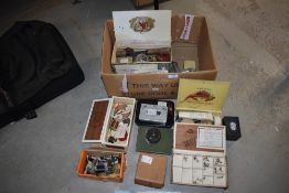 A mixed box of vintage fishing tackle including hooks reels line boxes and tins