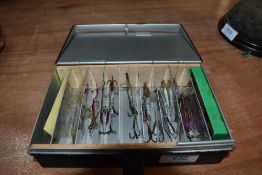 A Black metal compartment box containing lures including Hardy and allcocks