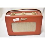 A vintage mid century Roberts transistor radio in red