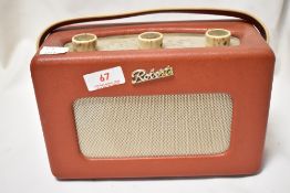 A vintage mid century Roberts transistor radio in red