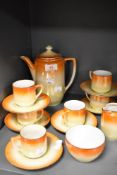 An Art Deco part coffee service having lustre orange and yellow fade glaze