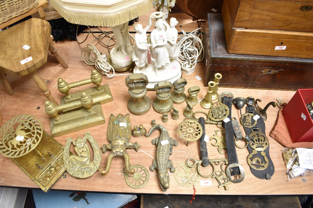 A large selection of brass wares, to include graduating bell weights, beetle boot jack, Martingales,