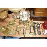 A large selection of brass wares, to include graduating bell weights, beetle boot jack, Martingales,