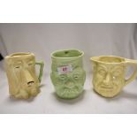 Three mid century ceramic character mugs including a dog, two headed man and military themed