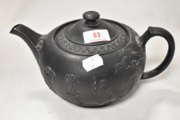 An early 19th century Wedgwood basalt teapot with a classical embossed body. In good condition