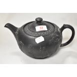 An early 19th century Wedgwood basalt teapot with a classical embossed body. In good condition