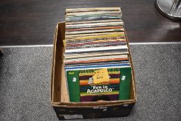 A box of around 100 mixed LP records, classical, rock and roll and more.
