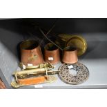 A selection of hardware including brass door handles and copper cider ladles