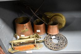 A selection of hardware including brass door handles and copper cider ladles