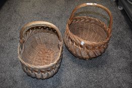 Two vintage woven wicker shopping baskets, of traditional design
