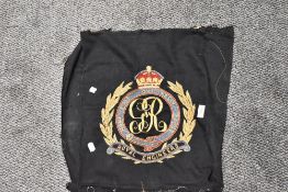 An embroidered Royal Engineers emblem with GR cipher, unframed with some deterioration to edges.