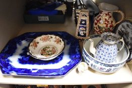 An assortment of vintage and antique ceramics, blue and white platters, fruit bowls, tea pot with