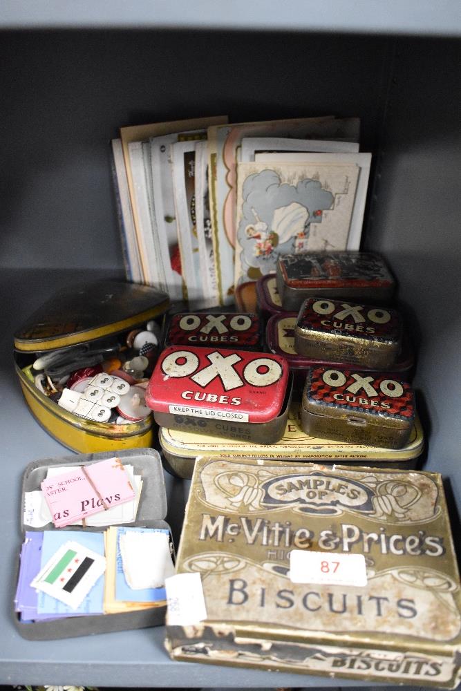 A selection of early 20th century advertising tins and postcards