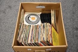 A box of 45 RPM singles, of rock and roll and easy listening interest, including The Beatles and The