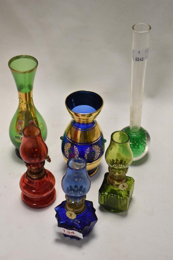 A selection of vintage miniature oil lamps and bud vases.
