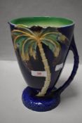 A Beswick 1028 vintage pitcher or water jug with Palm tree and deep blue glaze design 23cm tall