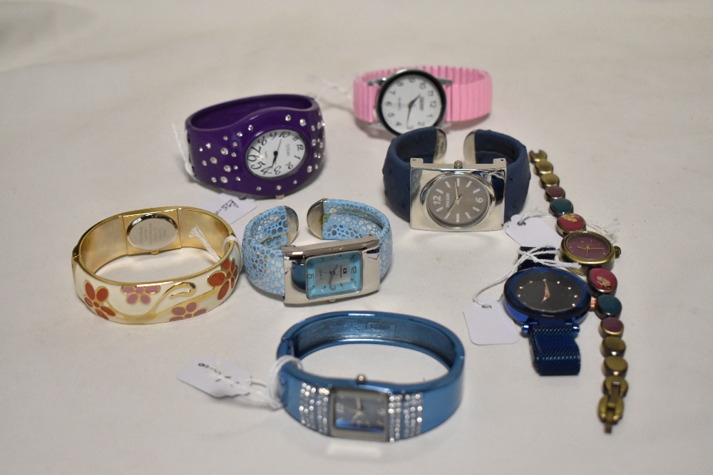Ten ladies silver tone watches, some having coloured faces.