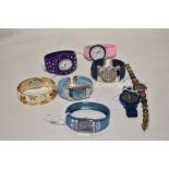 Ten ladies silver tone watches, some having coloured faces.