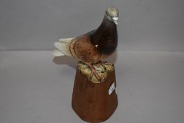 A Beswick figure study of pigeon no.1383B glued to wooden stand.