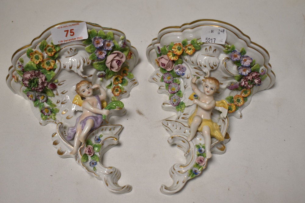 A pair of Sitzendorf Dresden porcelain wall sconces with floral and cherub designs
