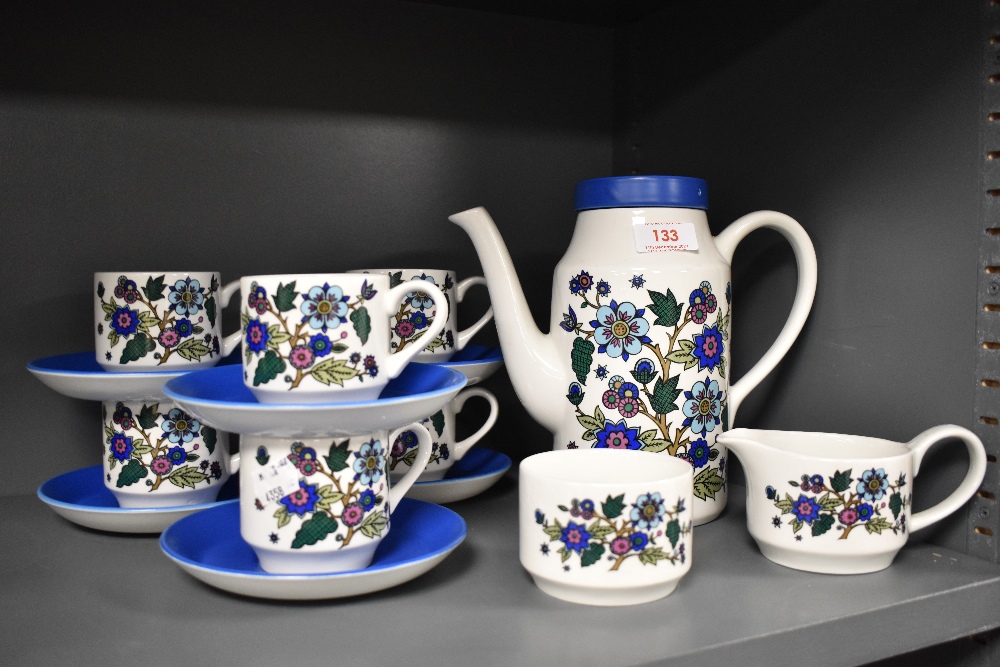 A selection of mid century Midwinter coffee cups, saucers and coffee pot, having floral decoration.