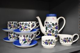 A selection of mid century Midwinter coffee cups, saucers and coffee pot, having floral decoration.