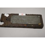A piece of antique timber with a pewter plaque reading ' Oak from support beam in Guy Fawkes