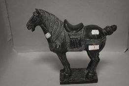 A 20th century stone carved Tang style horse figure, having repairs to base and tail. 26cm tall