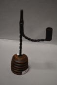 An antique rush light holder possibly 18th century or earlier having twisted wrought iron design