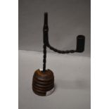 An antique rush light holder possibly 18th century or earlier having twisted wrought iron design