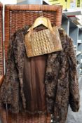 A vintage ladies Violet Tucker Astrakhan short length jacket with a crocodile skin handbag